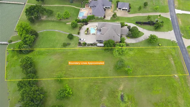 a view of a lush green outdoor space with a swimming pool and valleys in the background