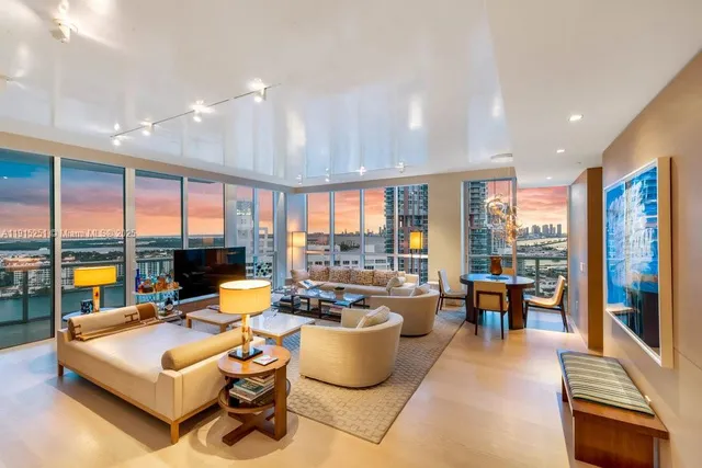 a living room with furniture and large windows