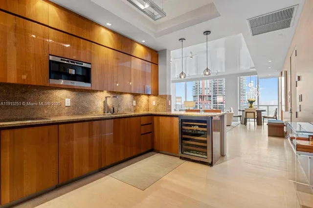a kitchen with kitchen island granite countertop a stove and cabinets