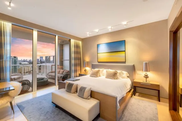 a bedroom with a bed and glass window