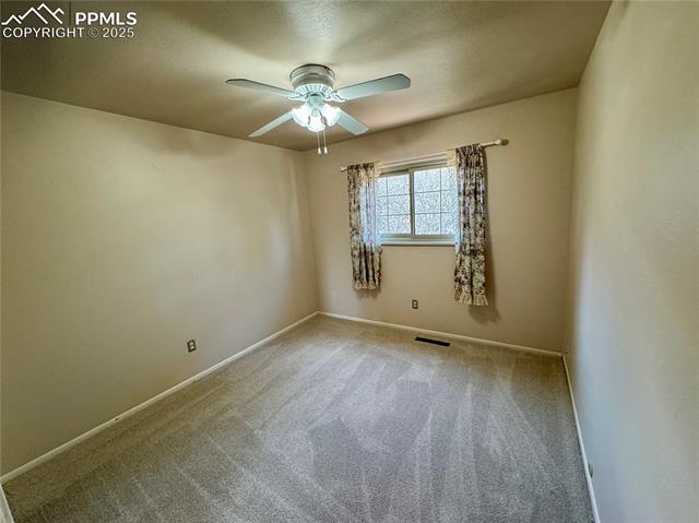 280 Raven Hills Road Colorado Springs, CO 80919 - Photo 32 of 48 Spare room featuring carpet floors, baseboards, ceiling fan, and visible vents