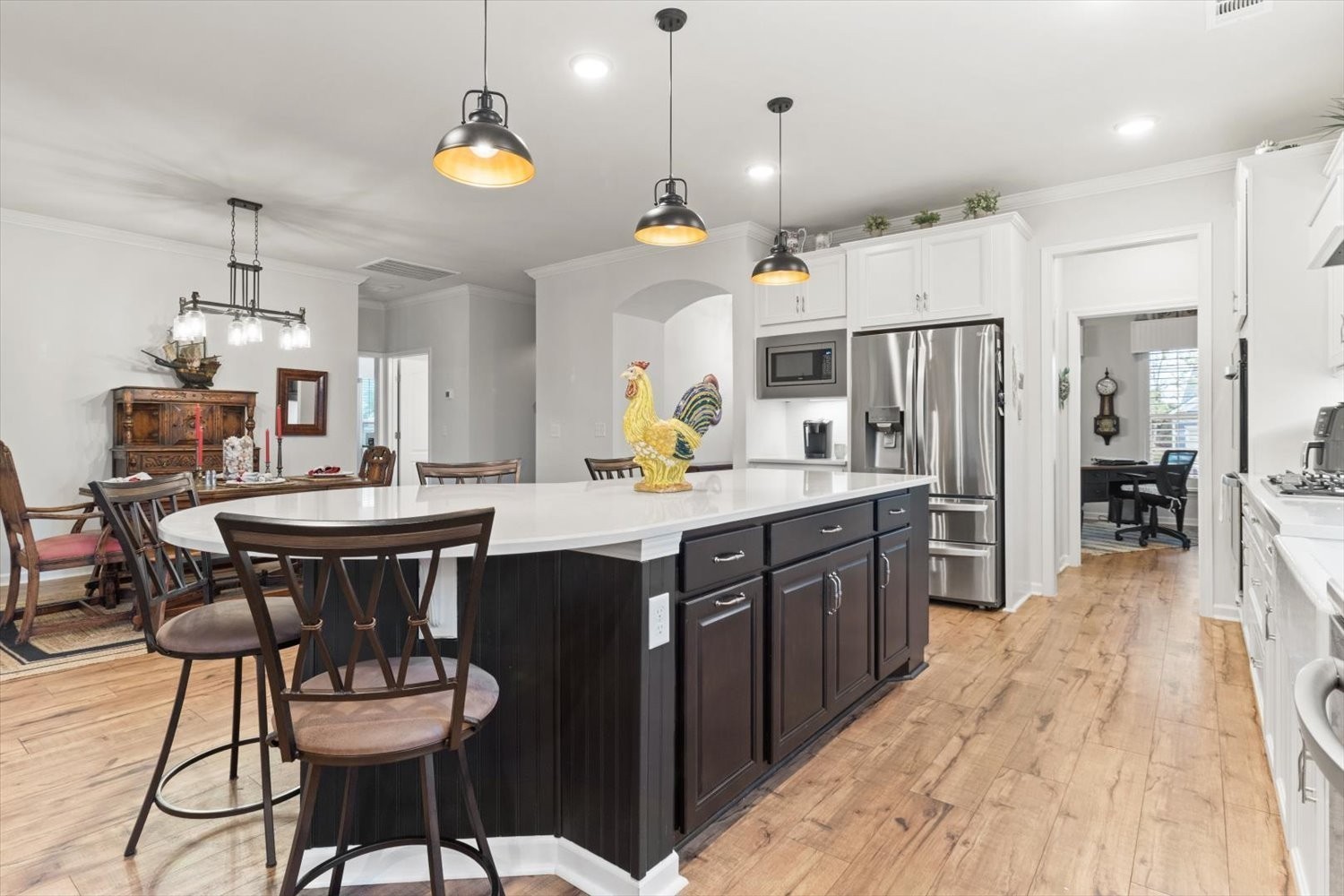 1055 Sumner Grove Spring Hill, TN 37174 - Photo 14 of 48 a kitchen with a dining table chairs stainless steel appliances and cabinets
