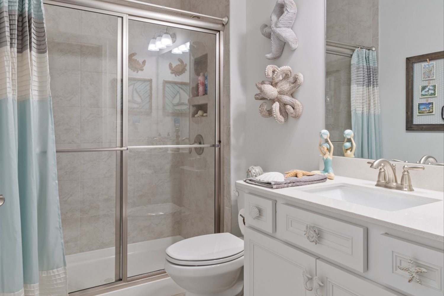 1055 Sumner Grove Spring Hill, TN 37174 - Photo 28 of 48 a bathroom with a granite countertop sink a toilet and a shower