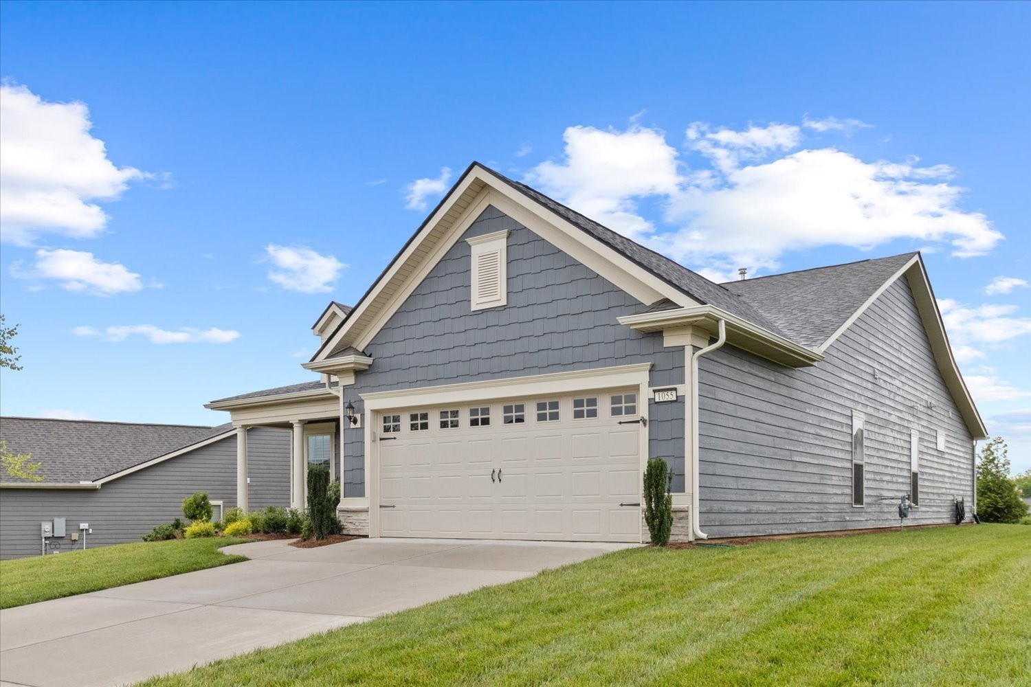 1055 Sumner Grove Spring Hill, TN 37174 - Photo 4 of 48 a view of a house with a yard and garage