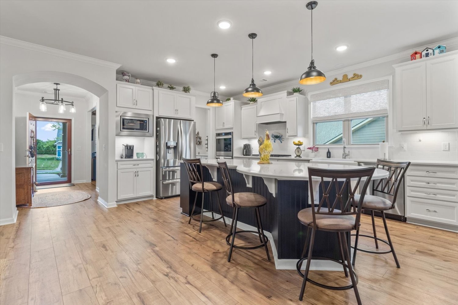 1055 Sumner Grove Spring Hill, TN 37174 - Photo 9 of 48 a kitchen with stainless steel appliances kitchen island granite countertop a table chairs and a refrigerator