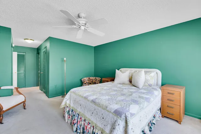 a bathroom with a double vanity sink toilet mirror and shower