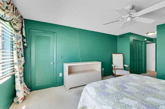 a white bath tub sitting in a bathroom next to a window