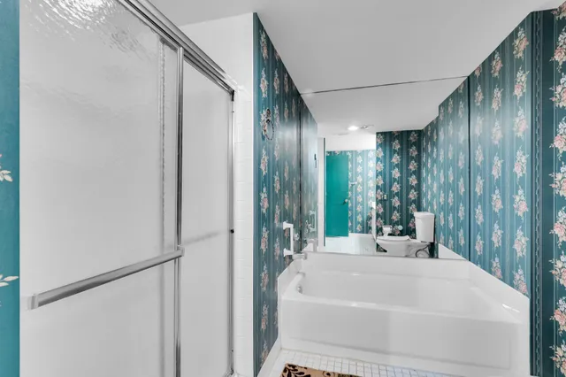 a living room filled with furniture and a potted plant