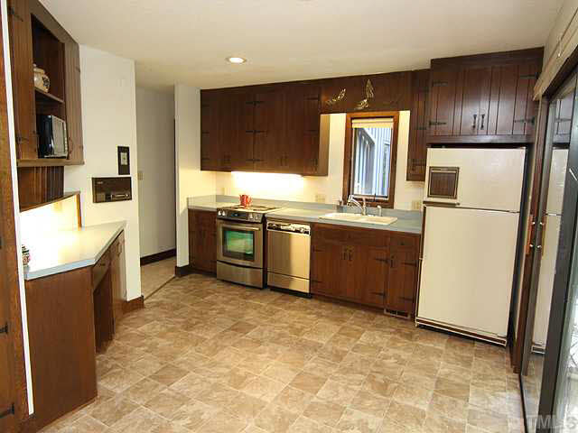 2713 Sherborne Place Raleigh, NC 27612 - Photo 4 of 25 Great kitchen layout that is open to living room. SS appliances including a new range/oven. New flooring and notice the glass sliders to the right. They exit to your covered deck! There is also plenty of room for a breakfast table is this space.