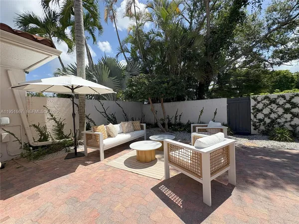 a view of a patio with table and chairs and potted plants