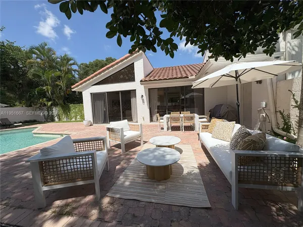 a view of a patio with a table and chairs