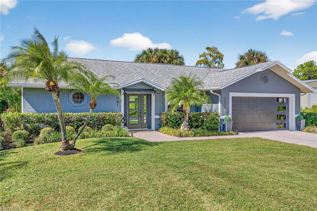 1081 9th Street Southwest Naples, FL 34117 - Photo 1 of 40 Ranch-style house featuring stucco siding, a front yard, concrete driveway, and an attached garage