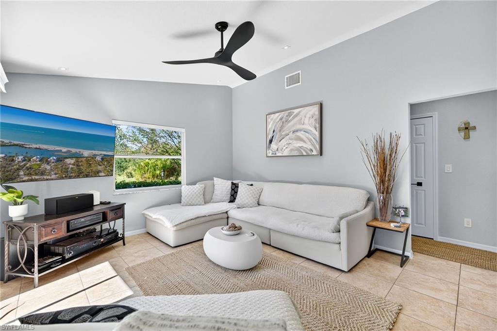1081 9th Street Southwest Naples, FL 34117 - Photo 15 of 40 Living area with light tile patterned floors and ceiling fan