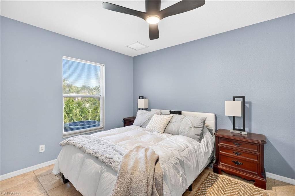 1081 9th Street Southwest Naples, FL 34117 - Photo 22 of 40 Bedroom with tile patterned floors and ceiling fan