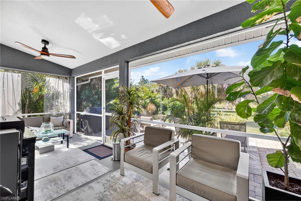 1081 9th Street Southwest Naples, FL 34117 - Photo 24 of 40 Sunroom / solarium featuring lofted ceiling, a textured wall, and concrete floors