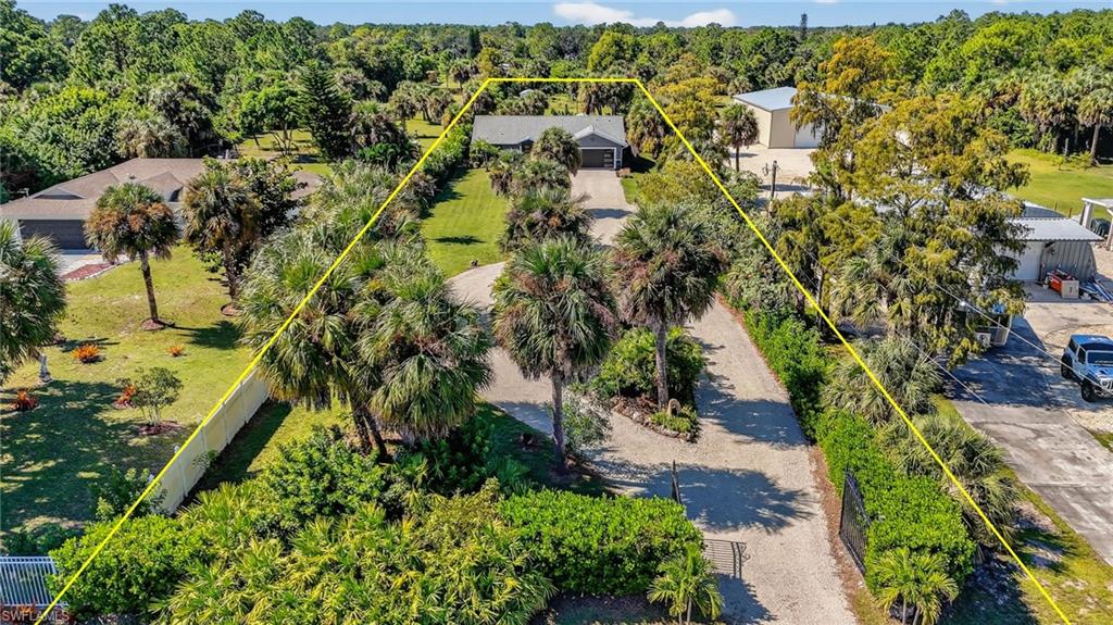 1081 9th Street Southwest Naples, FL 34117 - Photo 31 of 40 View from above of property with a heavily wooded area and property parcel outlined