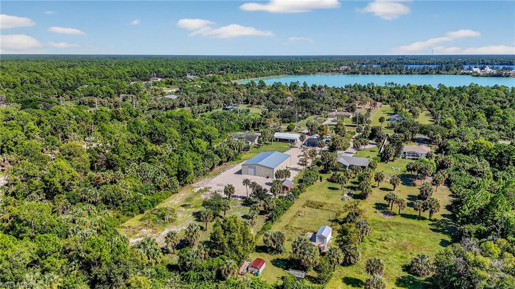 1081 9th Street Southwest Naples, FL 34117 - Photo 35 of 40 Aerial view of a nearby body of water and a forest