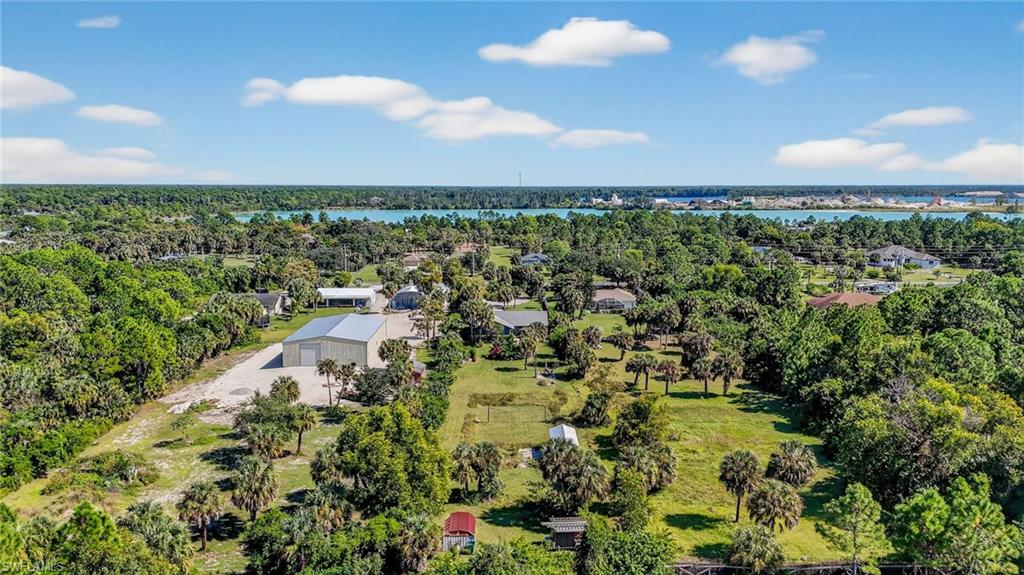 1081 9th Street Southwest Naples, FL 34117 - Photo 37 of 40 Drone / aerial view of a nearby body of water and a tree filled landscape