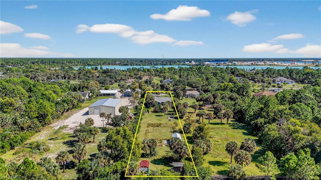 1081 9th Street Southwest Naples, FL 34117 - Photo 38 of 40 Aerial view of property and surrounding area featuring a large body of water and property boundaries highlighted