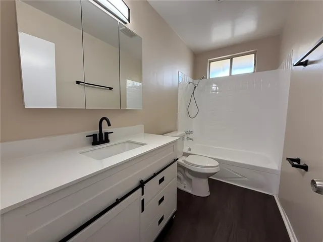 a bathroom with a double vanity sink toilet and shower