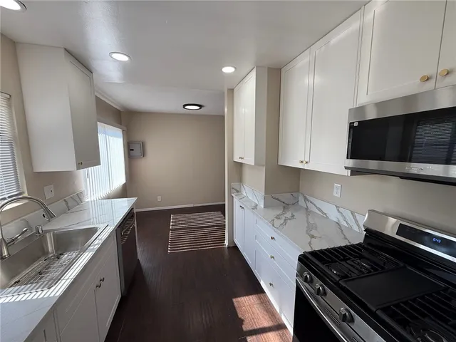 a kitchen with a sink stove and cabinets