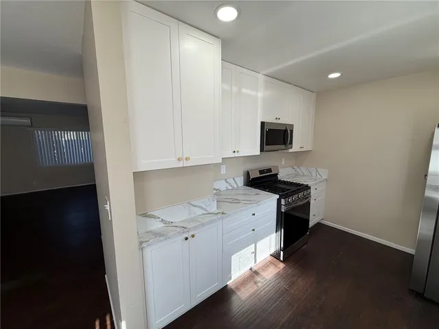 a kitchen with a sink cabinets and a stove top oven