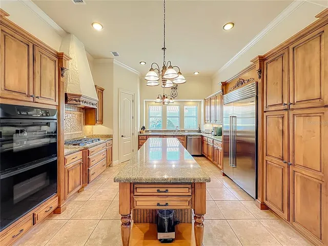 a view of an empty room with wooden floor and a ceiling fan