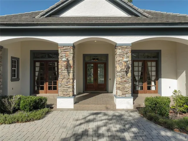 a living room with furniture a fireplace and a floor to ceiling window