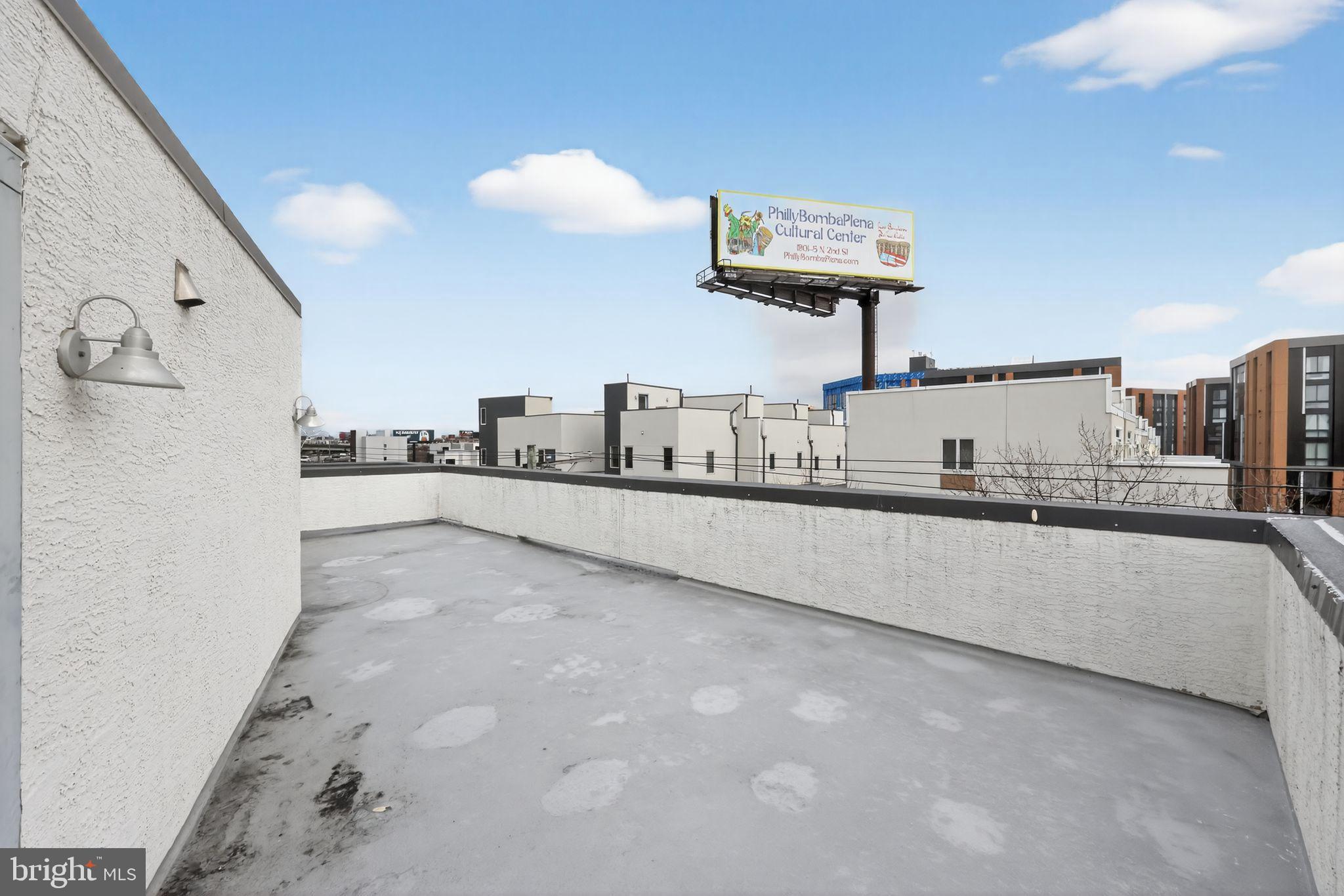 920 North Front Street Philadelphia, PA 19123 - Photo 26 of 28 a large kitchen with kitchen island a counter top a stove a chimney a sink and a counter top space