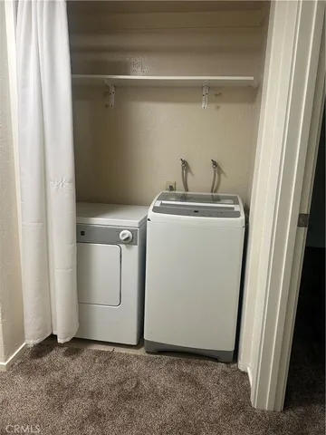 a view of storage and utility room with washer and dryer