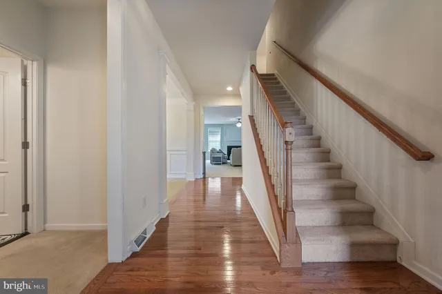 a view of entryway and hall with wooden floor