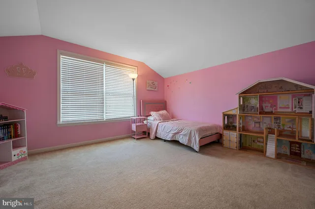 a bedroom with furniture and a dresser