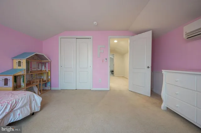 a spacious bedroom with a bed and a dresser