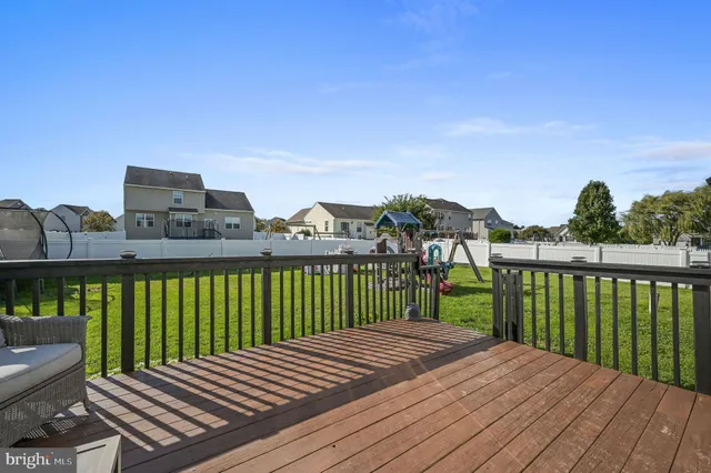 a view of a wooden balcony with two chairs