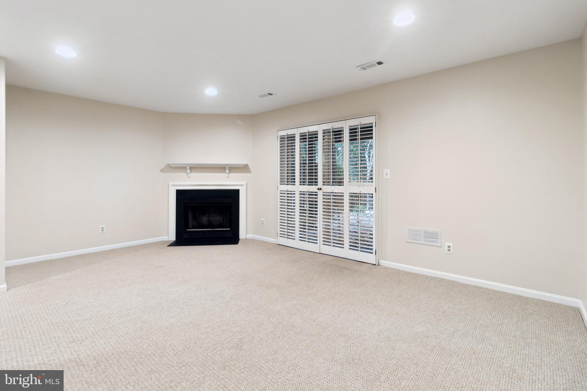 524 Kinsale Road Lutherville-Timonium, MD 21093 - Photo 17 of 22 an empty room with a fireplace and a window
