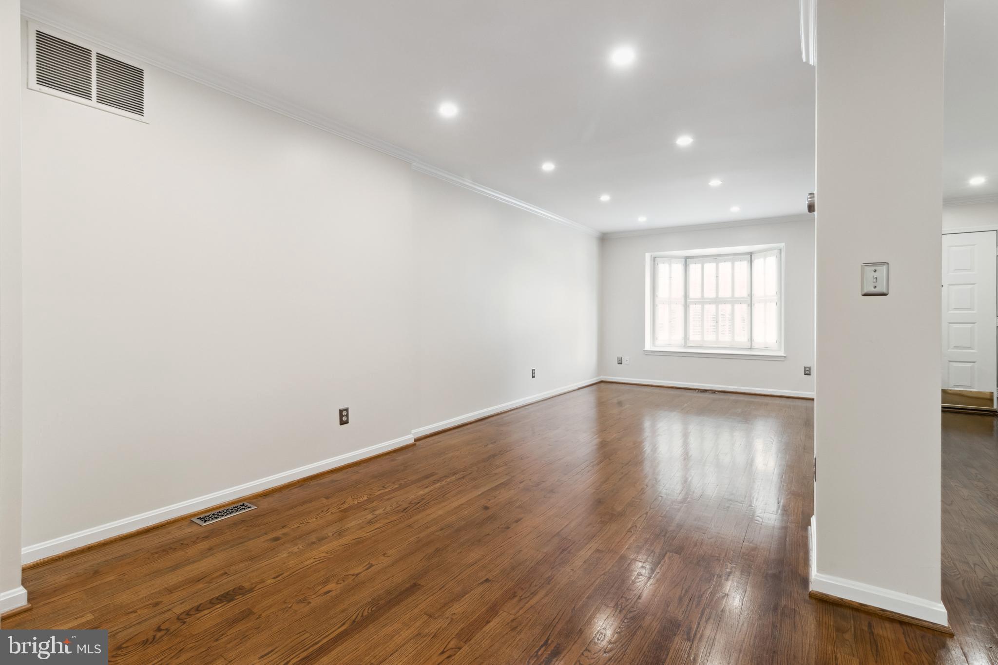 524 Kinsale Road Lutherville-Timonium, MD 21093 - Photo 6 of 22 an empty room with wooden floor and windows
