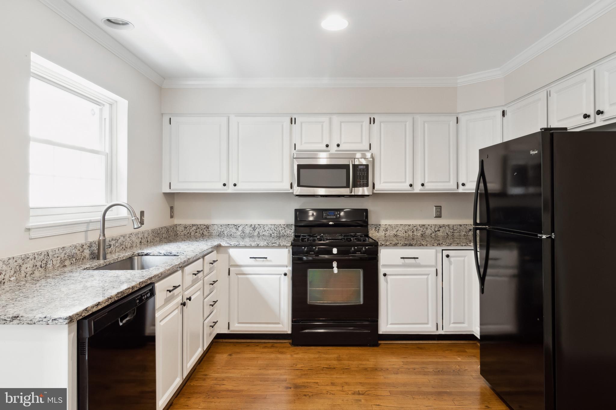 524 Kinsale Road Lutherville-Timonium, MD 21093 - Photo 9 of 22 a kitchen with a sink white cabinets and stainless steel appliances