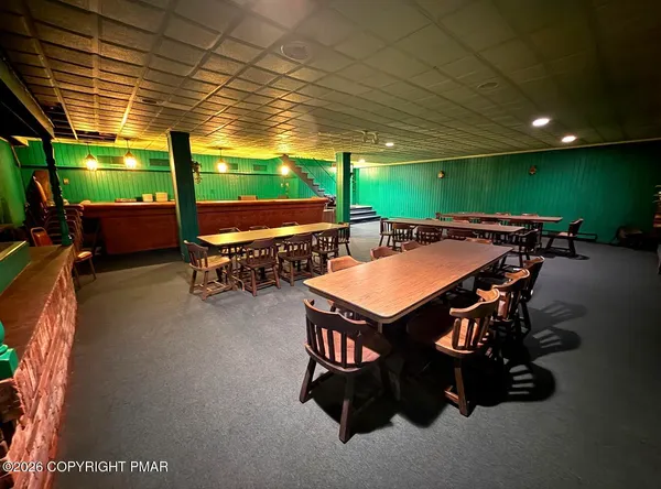a room with gym equipment pool table and windows