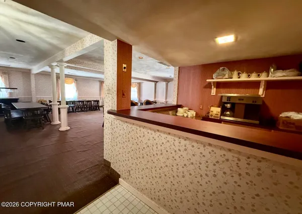 a living room with furniture a dining table and kitchen view