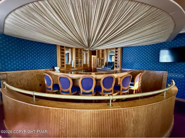 a wooden floor with glass top table and chairs