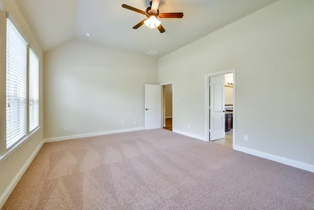 a view of a livingroom with a ceiling fan and window