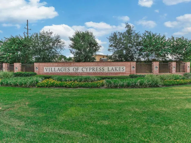 a sign that is sitting in the grass next to a building