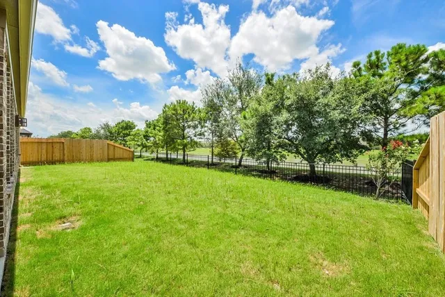 a view of yard with swimming pool and green space