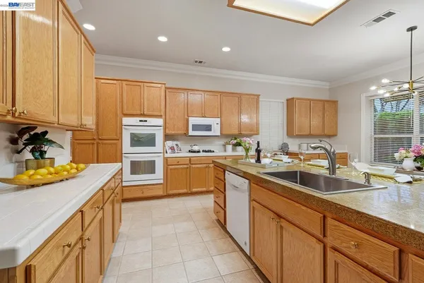 a kitchen with stainless steel appliances granite countertop sink stove and cabinets