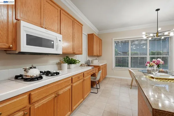 a kitchen with a stove a sink and a microwave