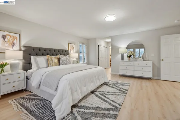 a spacious bedroom with a bed and a window