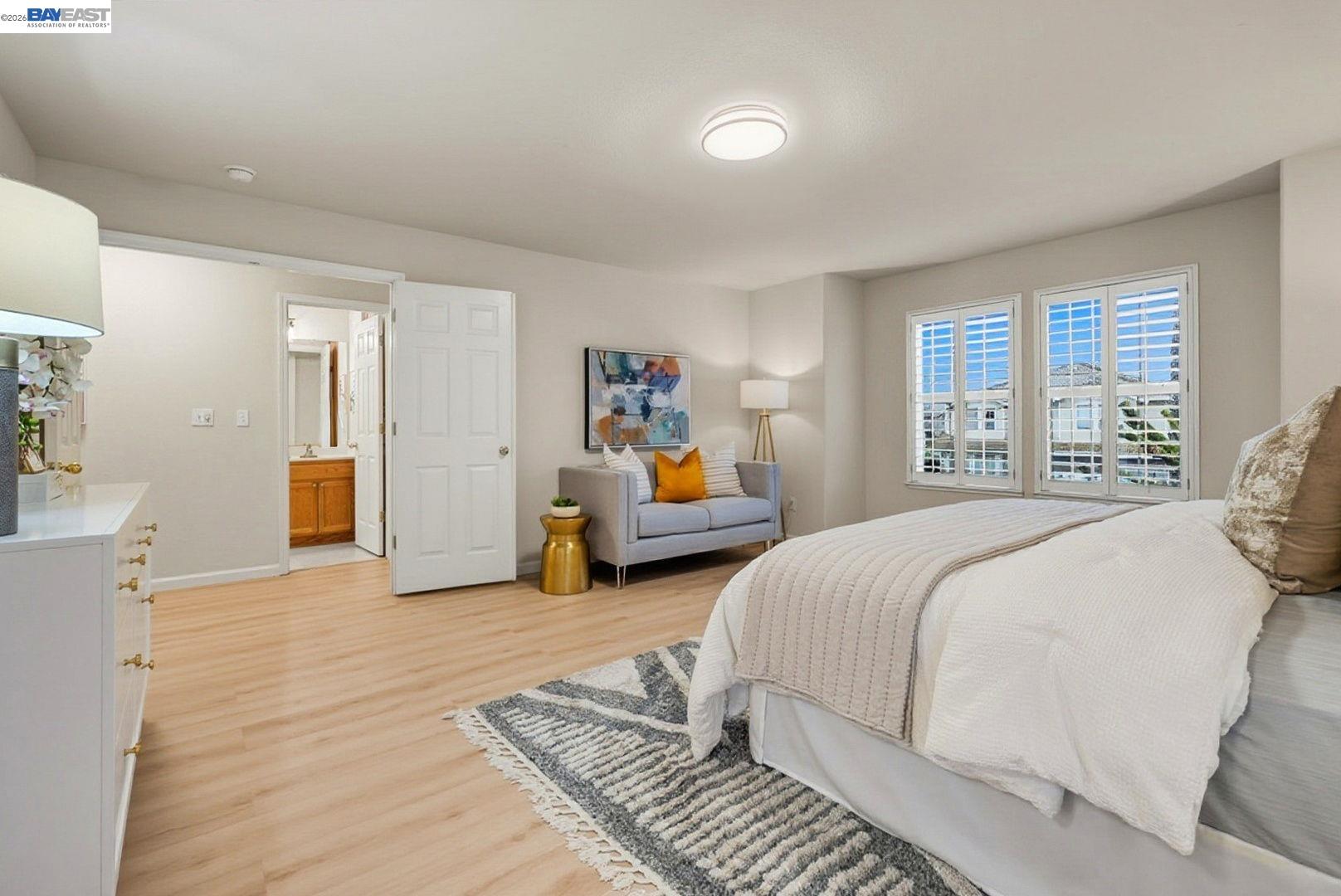 663 Clay Way Ripon, CA 95366 - Photo 21 of 43 a bedroom with a bed and wooden floor