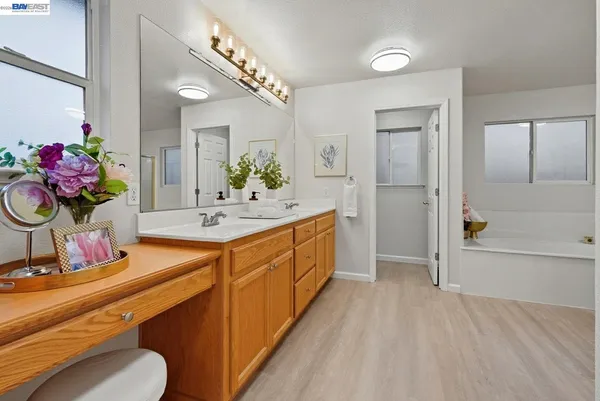 a bathroom with a double vanity sink mirror and chandelier