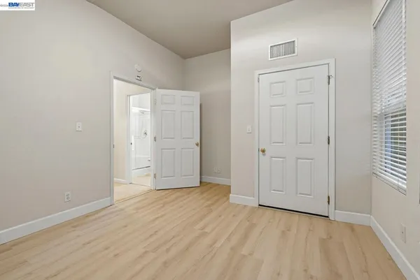 a view of an empty room with wooden floor