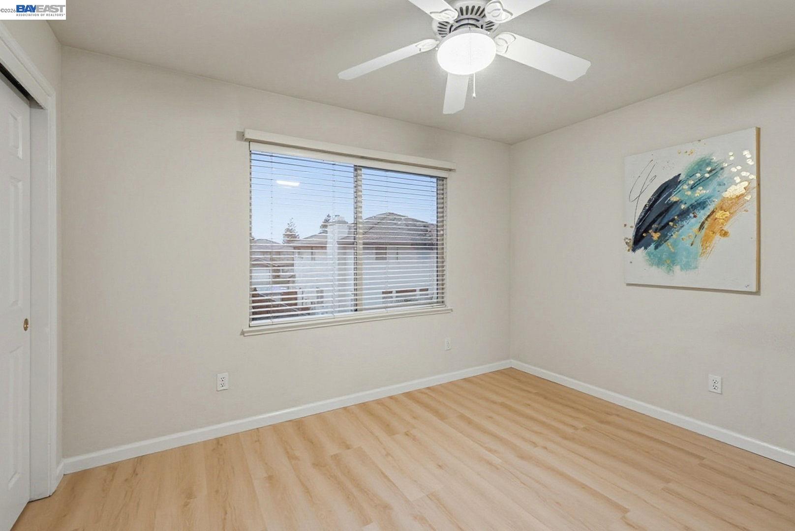 663 Clay Way Ripon, CA 95366 - Photo 29 of 43 a view of an empty room with wooden floor and a window